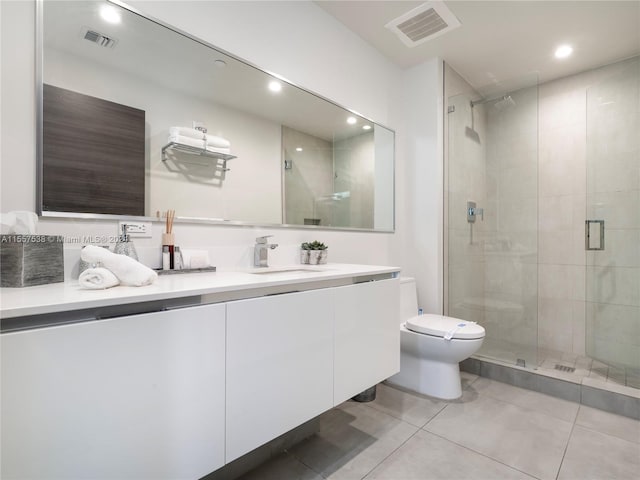 bathroom featuring tile patterned flooring, a shower with door, toilet, and vanity