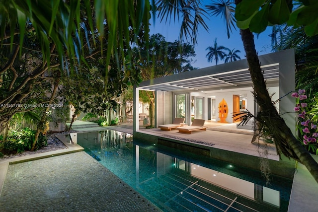 pool at night with a patio