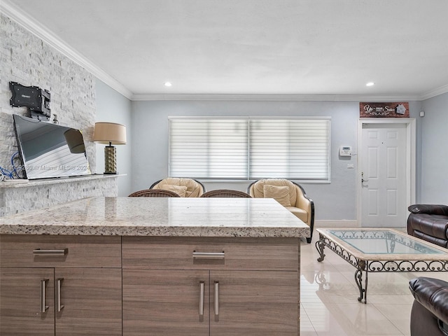 kitchen featuring light stone countertops, ornamental molding, and light tile floors