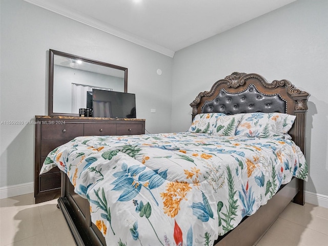 bedroom with light tile floors and crown molding