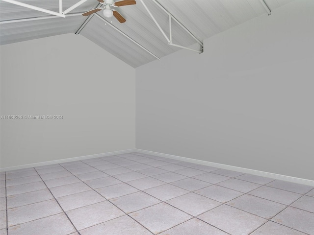 spare room with light tile floors, vaulted ceiling, and ceiling fan