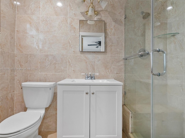 bathroom featuring tile walls, toilet, and vanity