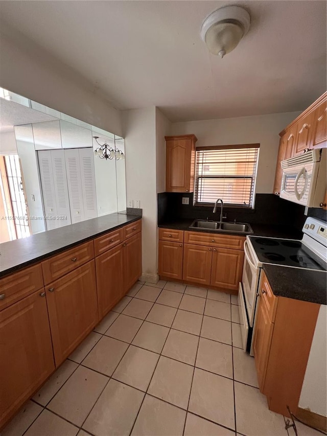 kitchen with white appliances, sink, and light tile floors