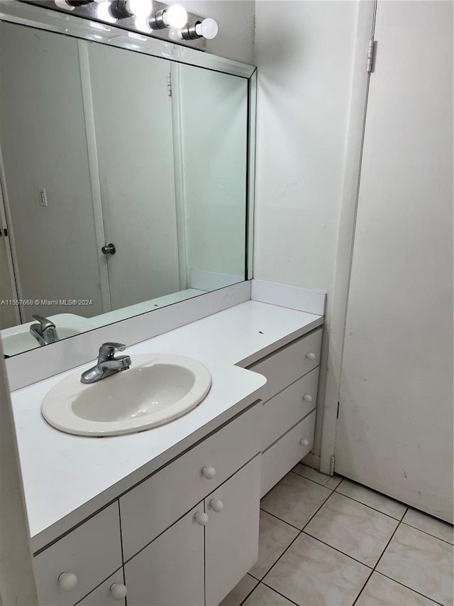 bathroom with tile flooring and vanity