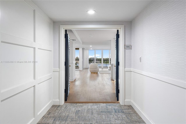 hallway with hardwood / wood-style flooring