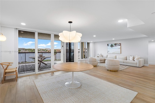 living room with light hardwood / wood-style flooring and floor to ceiling windows