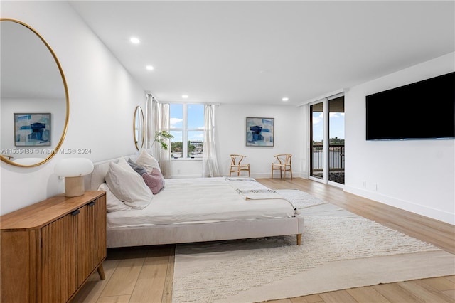 bedroom featuring light hardwood / wood-style flooring and access to outside