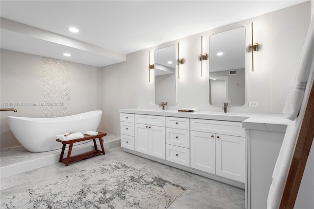 bathroom with vanity and a washtub