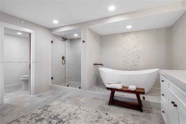 full bathroom featuring separate shower and tub, vanity, and toilet