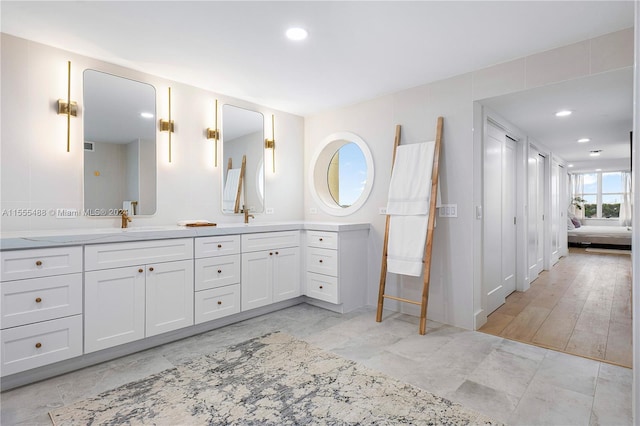 bathroom with hardwood / wood-style flooring and vanity