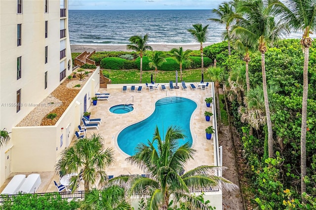 view of pool featuring a patio and a water view