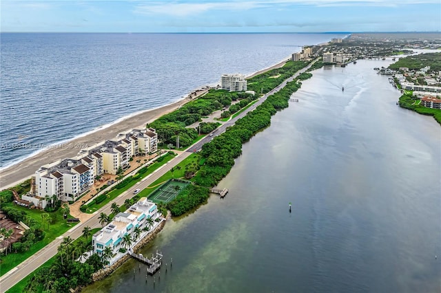 birds eye view of property featuring a beach view and a water view