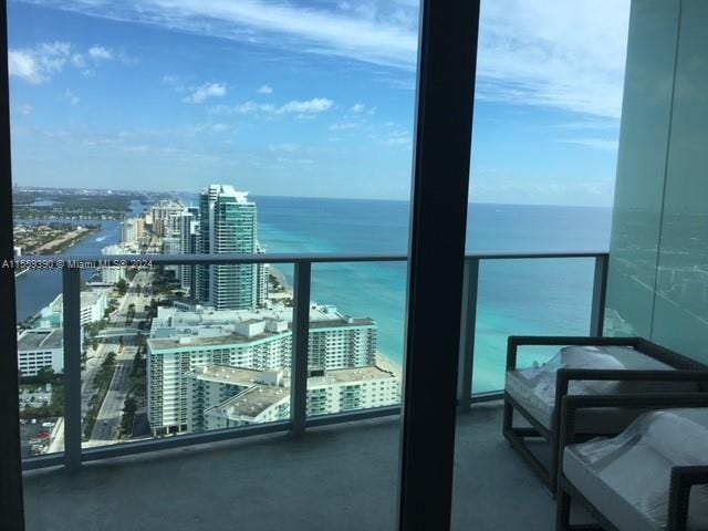 balcony featuring a water view