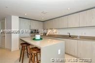 kitchen featuring a kitchen island, a breakfast bar area, and sink