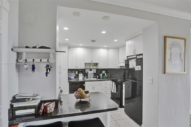 kitchen with sink, black appliances, white cabinets, light tile patterned flooring, and kitchen peninsula