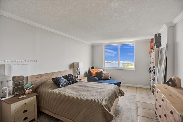 tiled bedroom featuring crown molding, a water view, and a textured ceiling