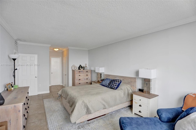 bedroom featuring ornamental molding, light tile patterned floors, and a textured ceiling