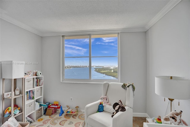 game room with crown molding, a water view, light tile patterned flooring, and a textured ceiling