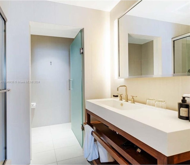 bathroom with vanity, a shower with door, and tile flooring