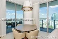 dining room with an inviting chandelier, floor to ceiling windows, and radiator