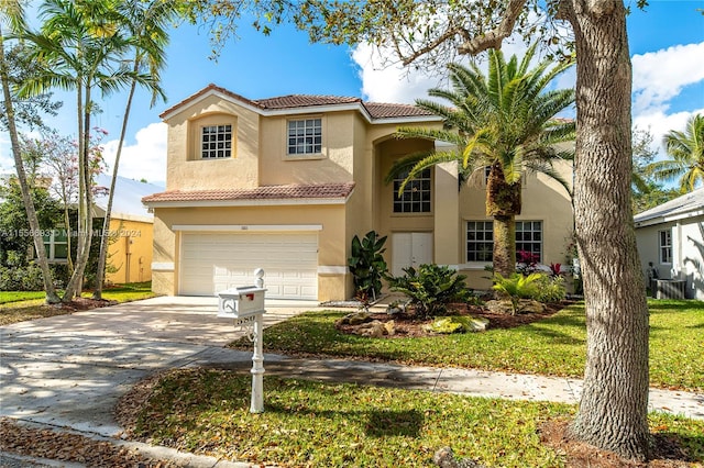 mediterranean / spanish house with a front yard and a garage