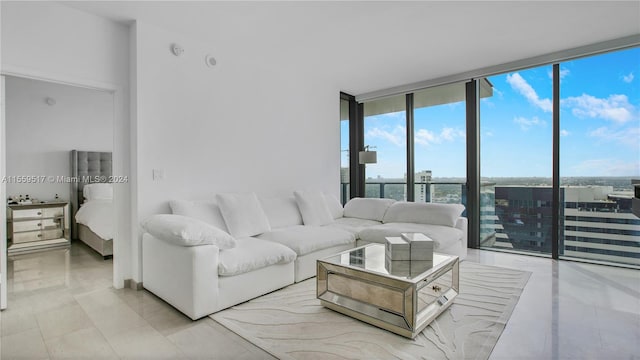 living room with light tile flooring and a wall of windows