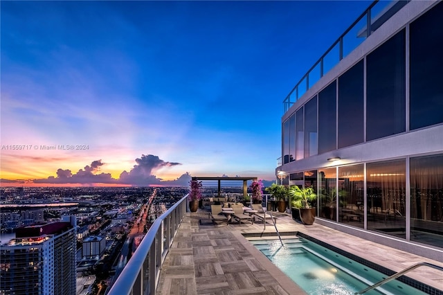 pool at dusk with a patio