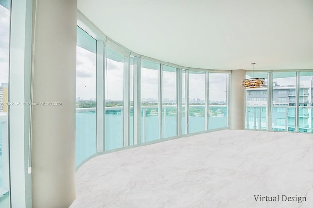 interior space with floor to ceiling windows, a water view, and a wealth of natural light