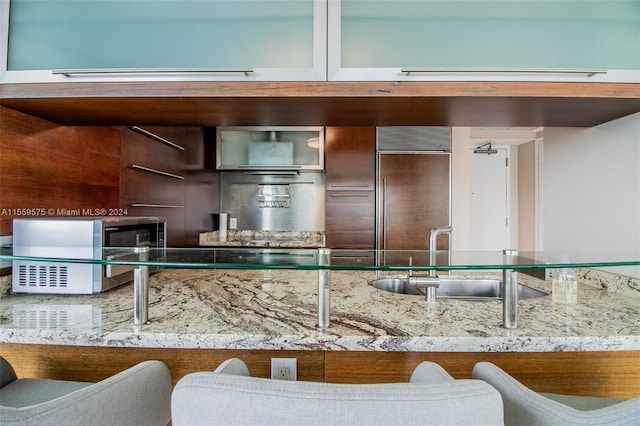 kitchen with built in fridge and sink