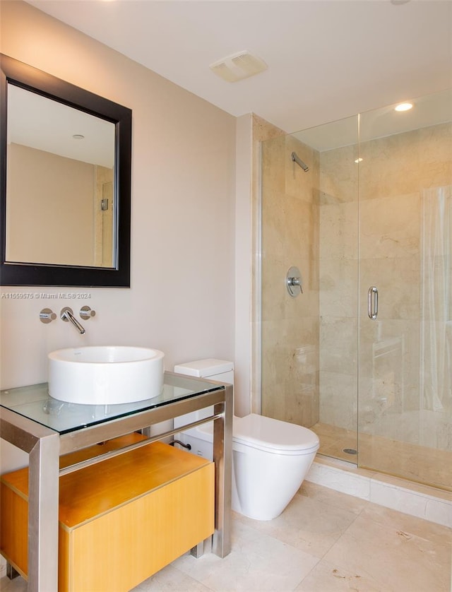 bathroom featuring an enclosed shower, toilet, and sink