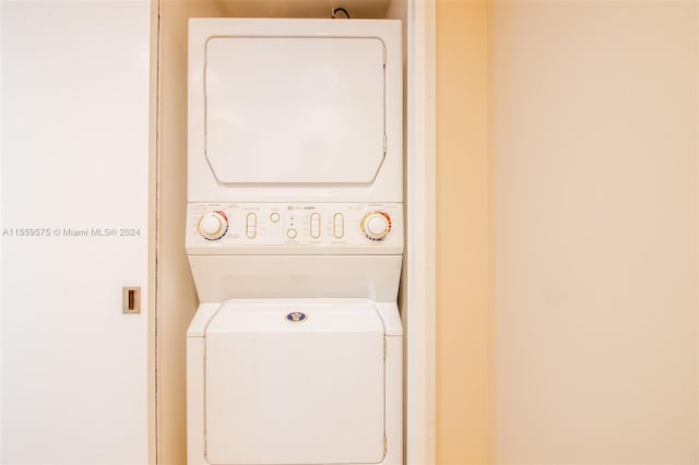 laundry area with stacked washer and clothes dryer