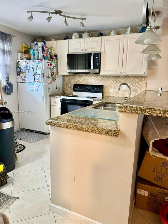 kitchen featuring backsplash, light tile floors, white appliances, and sink