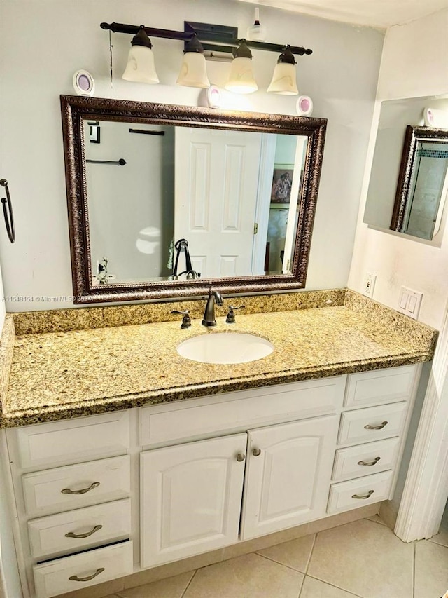 bathroom featuring vanity with extensive cabinet space and tile floors