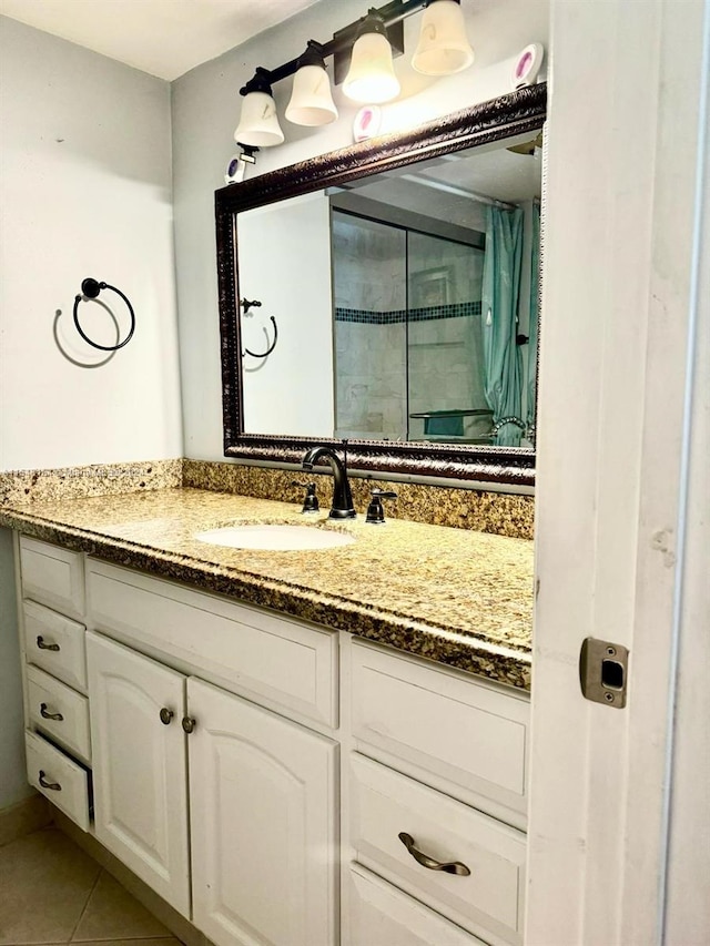 bathroom with vanity and tile flooring