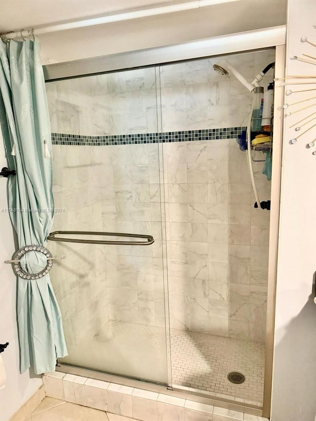 bathroom with a shower with door