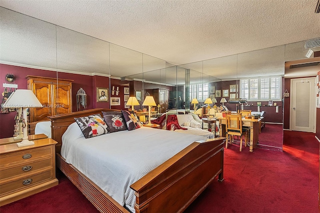 bedroom featuring a textured ceiling and dark carpet