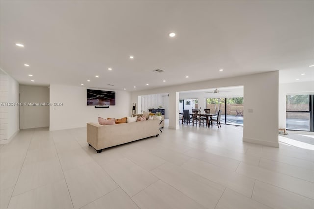 living room featuring a healthy amount of sunlight and light tile floors