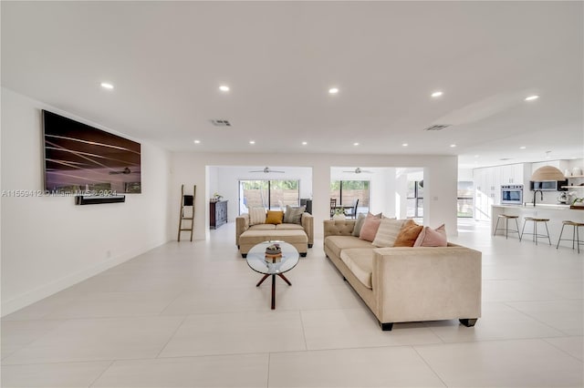 tiled living room with ceiling fan