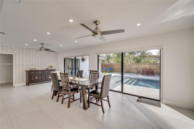 dining space with ceiling fan and light tile floors