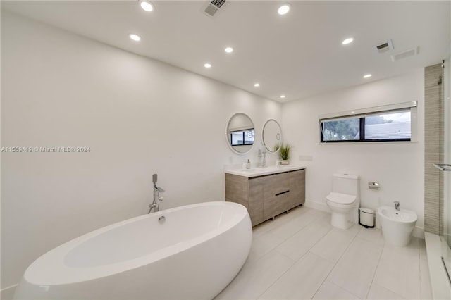 bathroom with a bidet, toilet, tile floors, a bathtub, and vanity