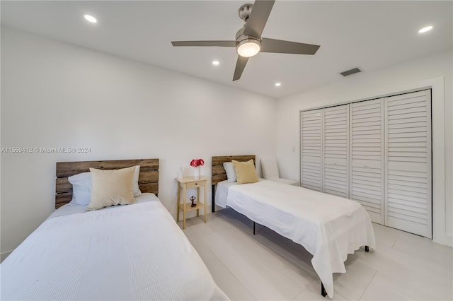 bedroom with a closet, ceiling fan, and light tile floors