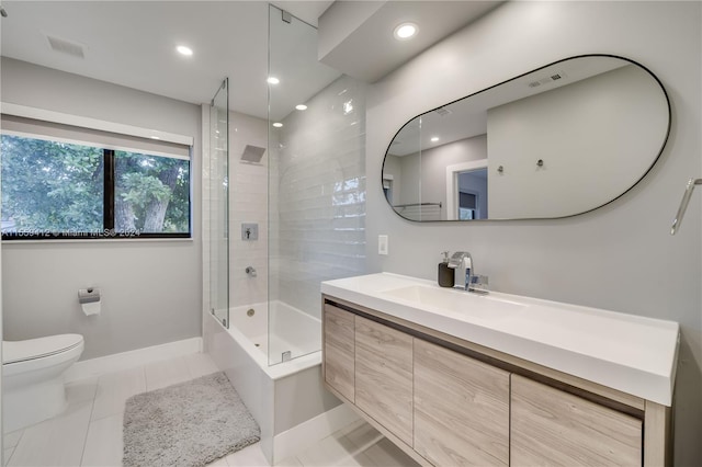 full bathroom with tile flooring, vanity, toilet, and tiled shower / bath