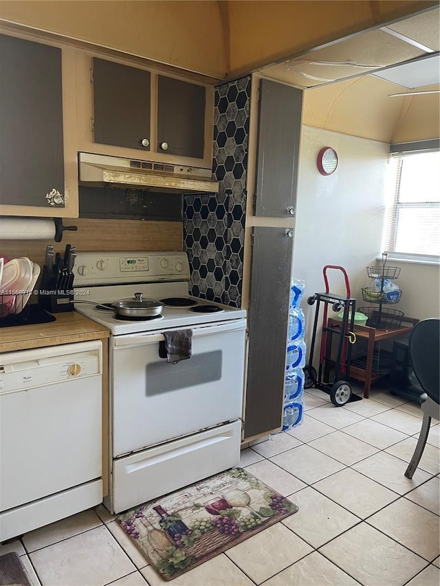 kitchen featuring white appliances and light tile floors