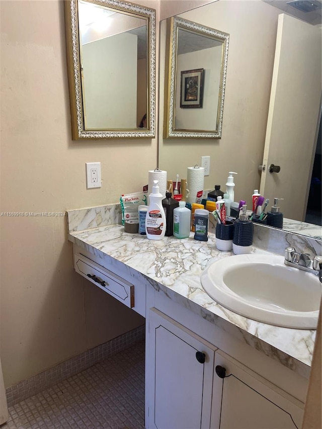 bathroom with vanity and tile flooring