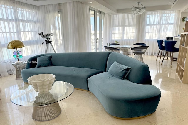 tiled living room featuring a notable chandelier