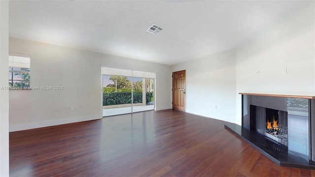 unfurnished living room featuring dark wood-type flooring