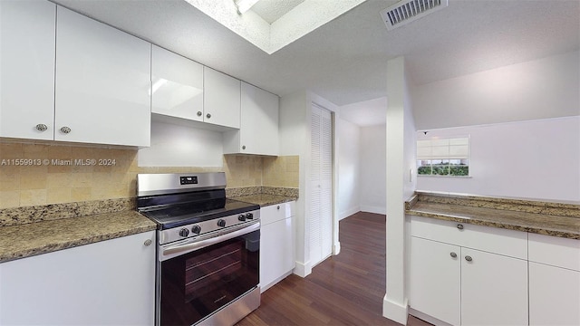 kitchen with a skylight, electric stove, backsplash, and dark hardwood / wood-style floors