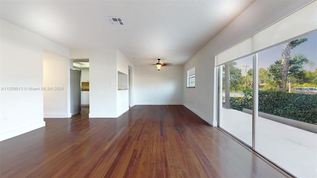 spare room with dark wood-type flooring