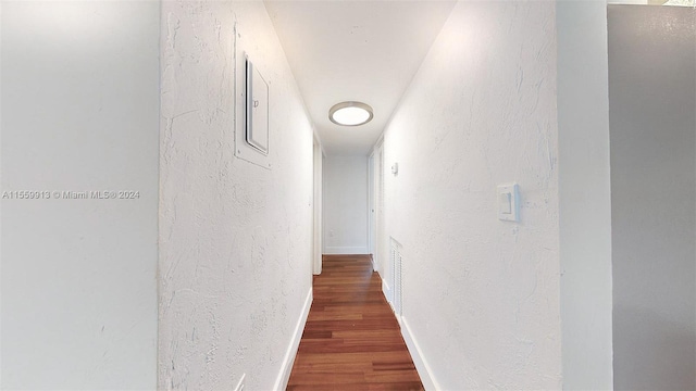 corridor with dark hardwood / wood-style flooring