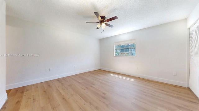 unfurnished room featuring ceiling fan, a textured ceiling, and light wood-type flooring